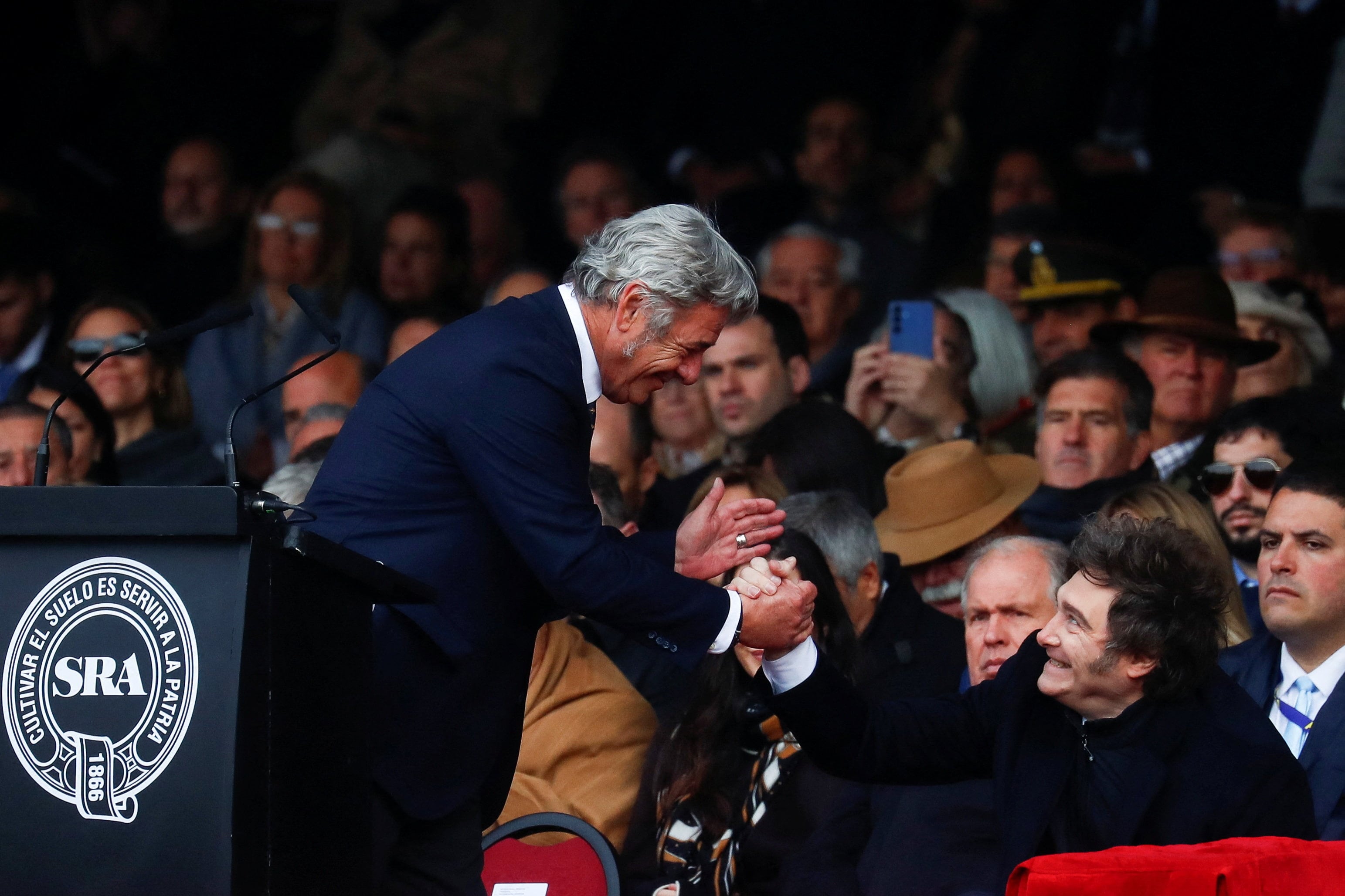Argentina's President Javier Milei and President of the Argentine Rural Society Nicolas Pino shake hands during the official opening ceremony of the Rural Society's 137th annual exhibition, in Buenos Aires, Argentina, July 26, 2025. REUTERS/Matias Baglietto