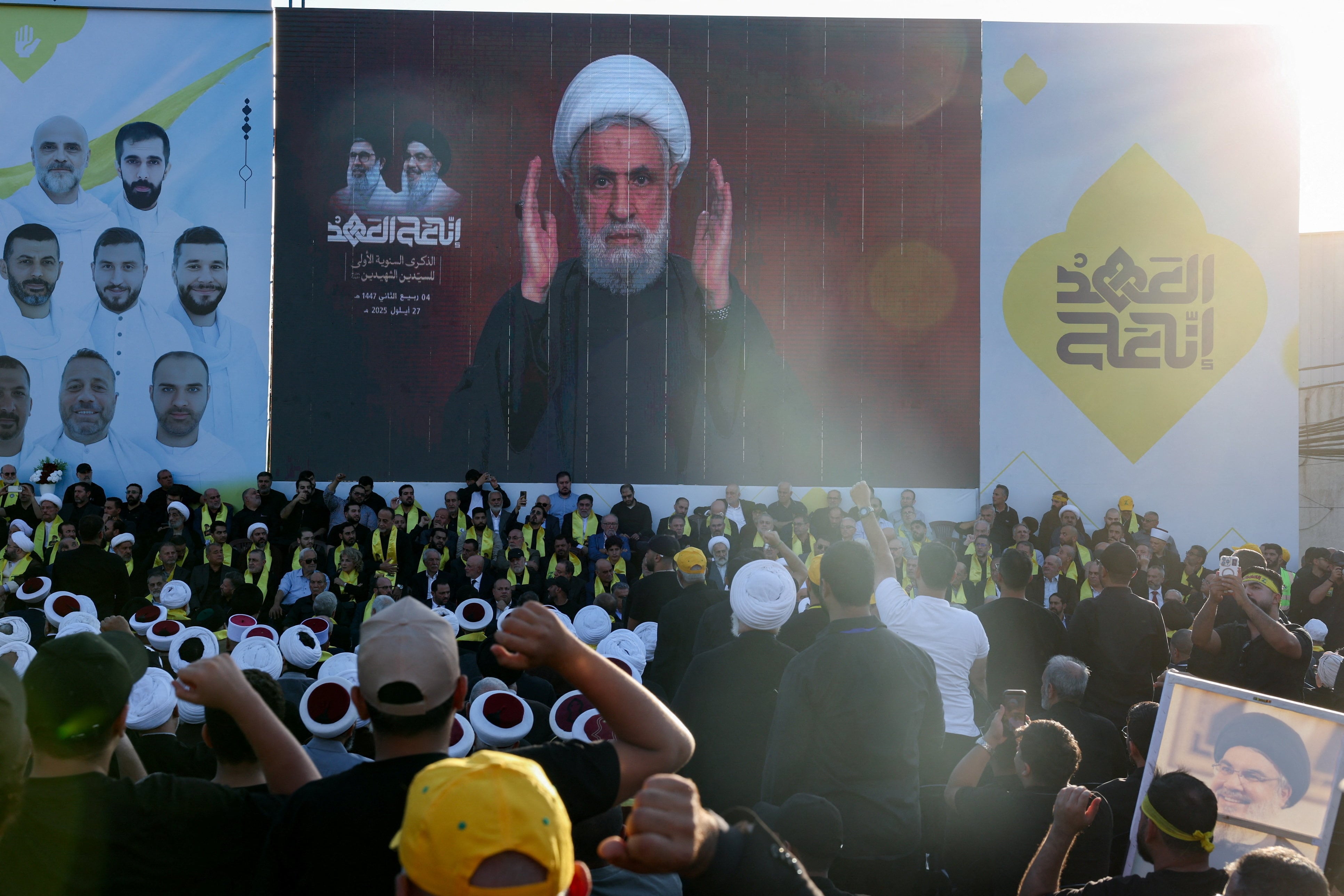 Naim Qassem, aparece en una pantalla pronunciando un discurso durante una ceremonia celebrada por Hezbollah para conmemorar el primer aniversario del asesinato de su difunto líder, Hassan Nasrallah, a manos de Israel, en las afueras de Beirut, Líbano, el 27 de septiembre de 2025. REUTERS/Mohamed Azakir