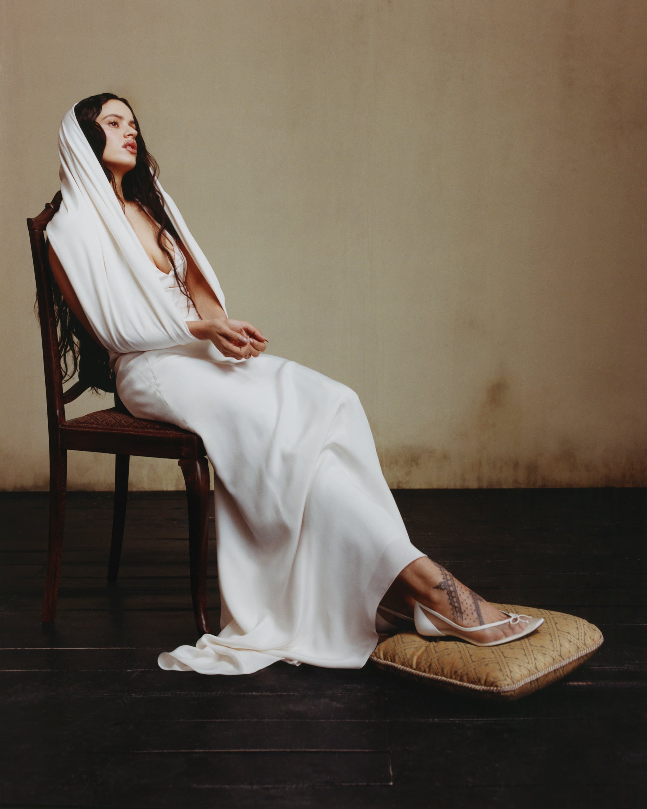 The Catalan artist wearing a long V-necked dress by Max Mara and shoes by Jacquemus.