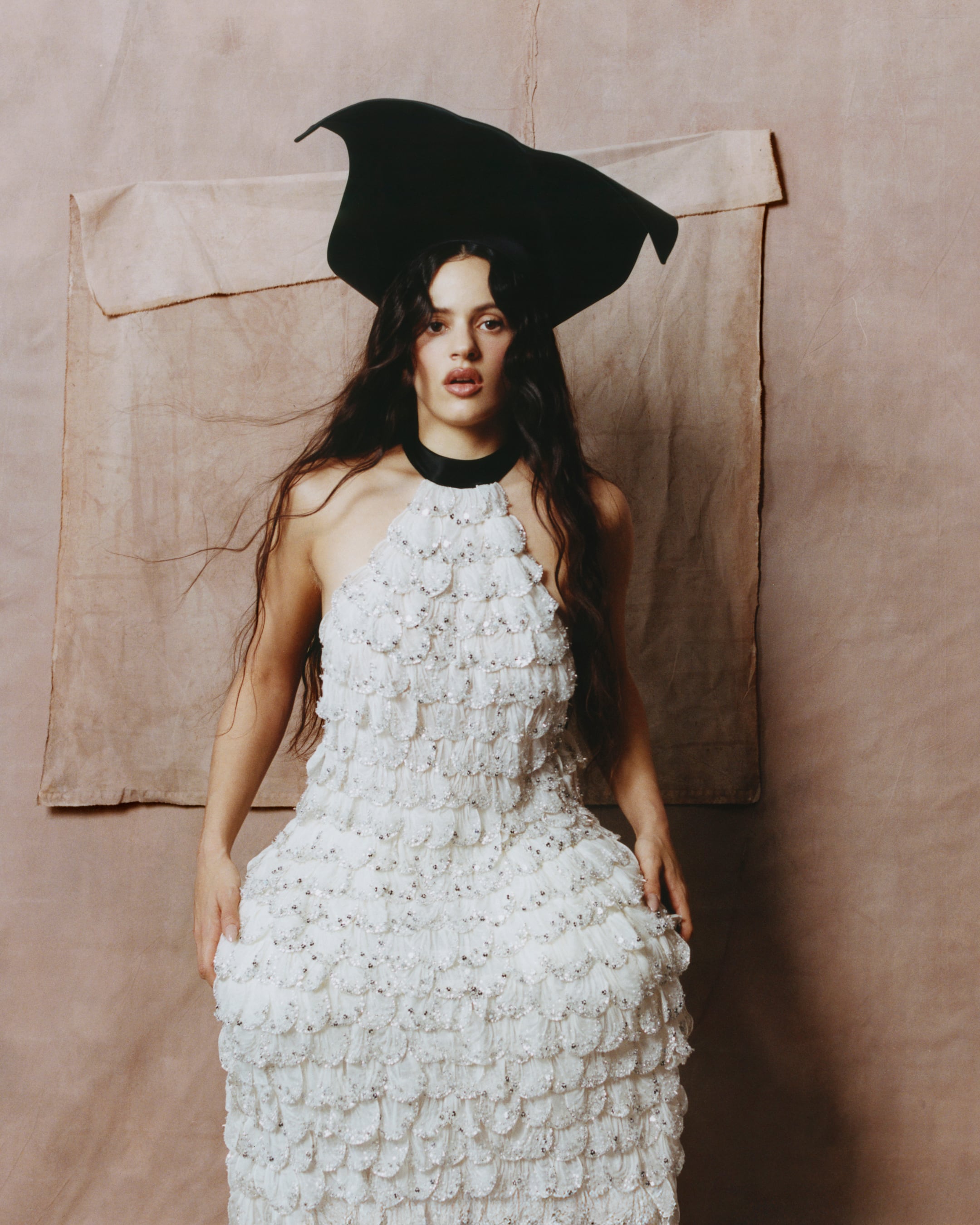 The singer wearing a midi dress and a hat, both by Dior.