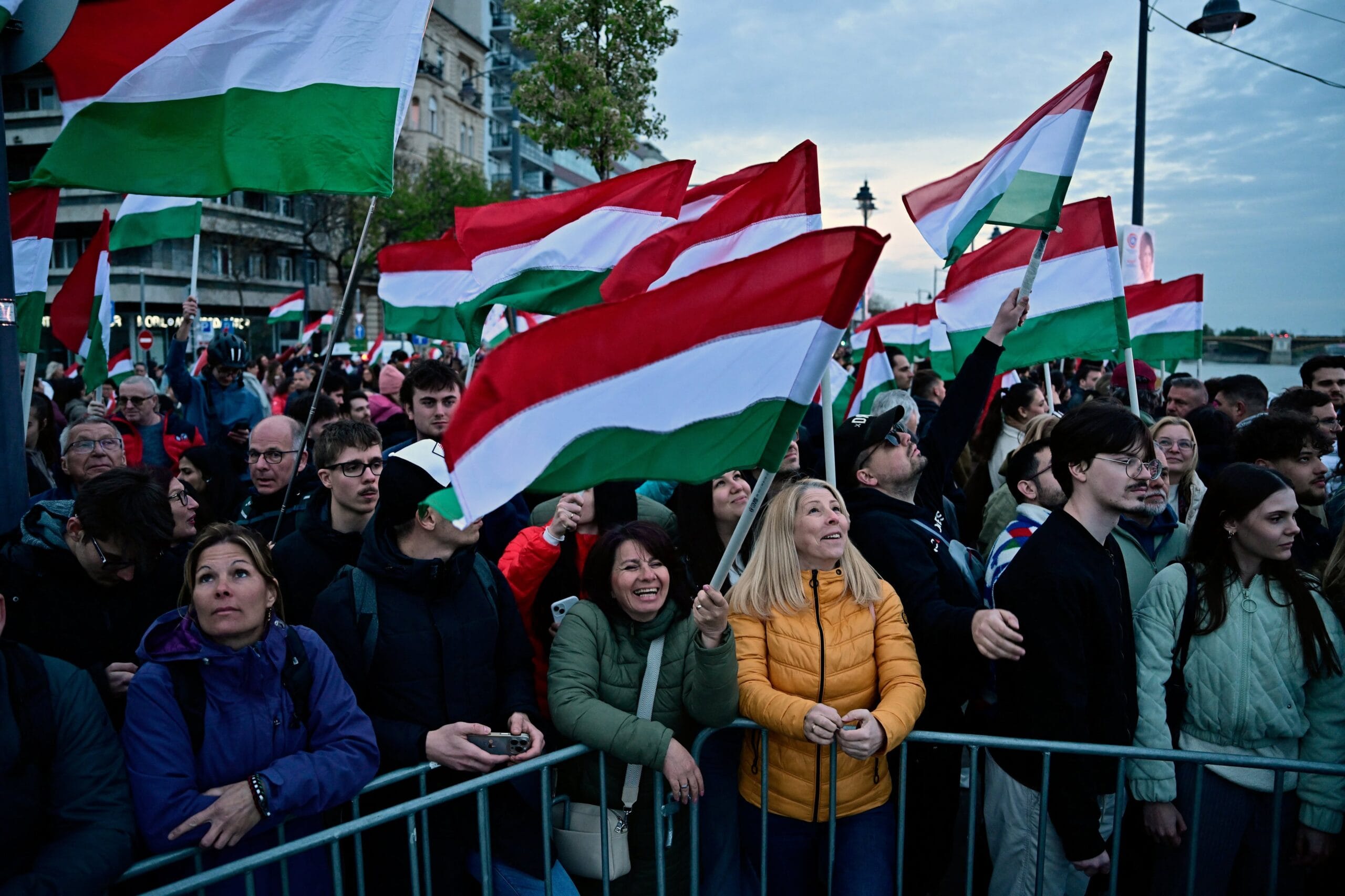 Varias personas sostienen banderas húngaras, mientras esperan a Peter Magyar, líder del partido opositor Tisza, el día de las elecciones parlamentarias, en Budapest, Hungría, 12 de abril de 2026. REUTERS/Marton Monus