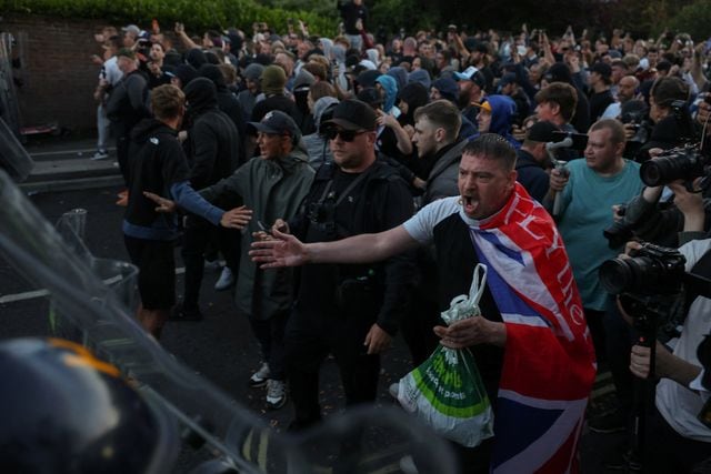 Protesters stand facing police officers during a demonstration following the conviction of Vikrum Digwa for the murder of student Henry Nowak, in Southampton, Britain, June 2, 2026. REUTERS/Isabel Infantes