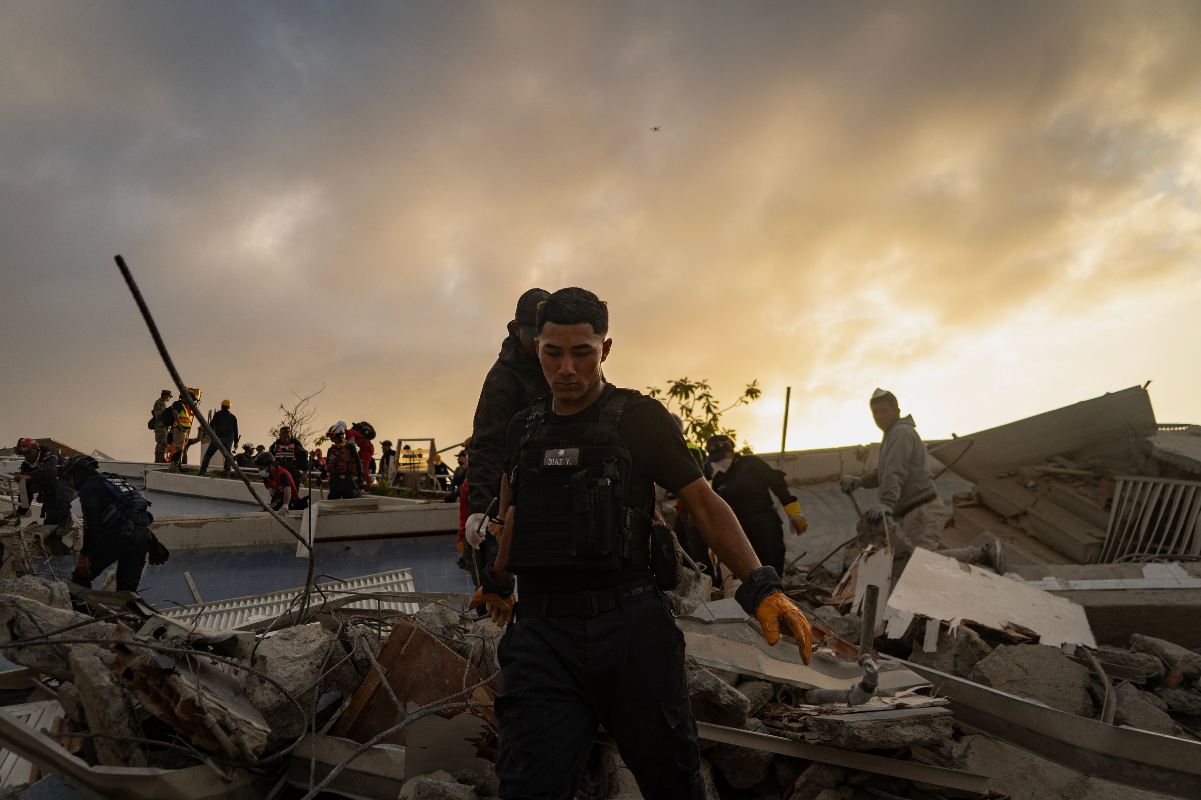 Personas participan en labores de búsqueda y rescate en el edificio donde vivióa la familia, en La Guaira, el 28 de junio.
